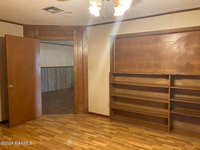 interior space with a chandelier, a textured ceiling, and light hardwood / wood-style flooring