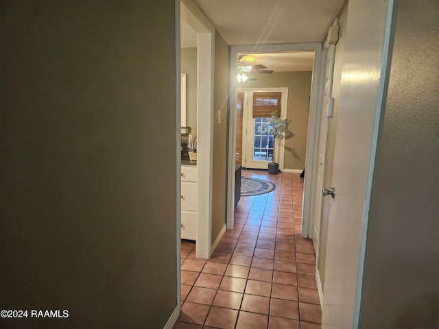 hall featuring light tile patterned flooring