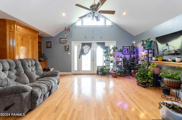 living room featuring ceiling fan, light hardwood / wood-style floors, and high vaulted ceiling