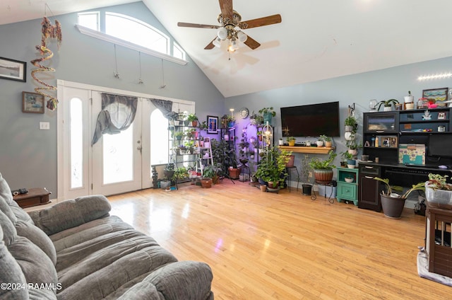 living room with ceiling fan, high vaulted ceiling, and light hardwood / wood-style floors