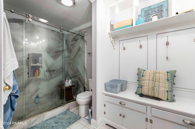 bathroom featuring ornamental molding, tile patterned flooring, a shower with shower door, and toilet