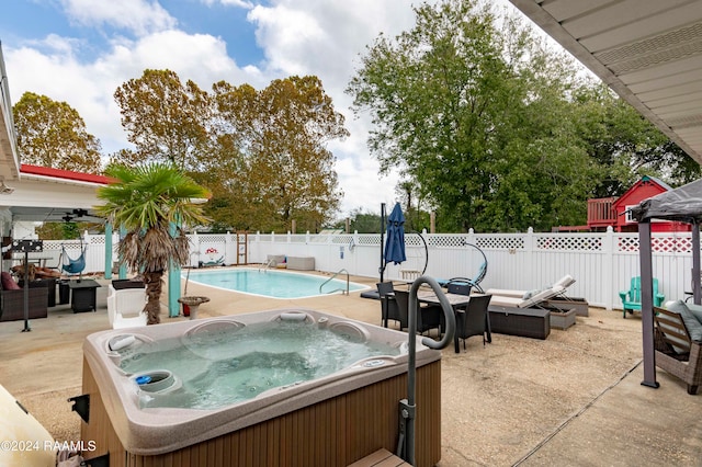 view of pool featuring a hot tub and a patio area