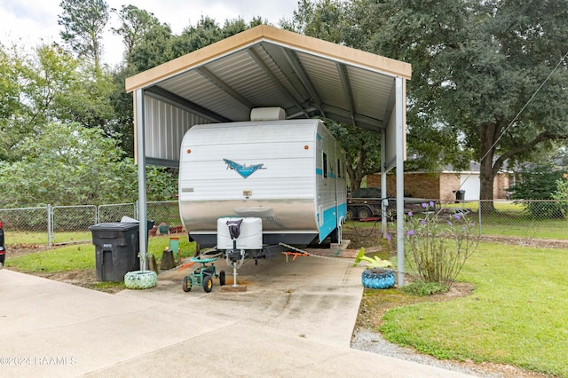 view of outbuilding with a carport and a lawn