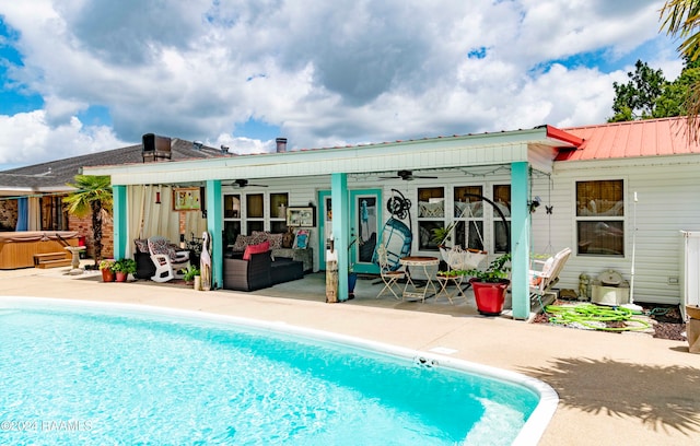 rear view of house featuring a swimming pool with hot tub, an outdoor hangout area, ceiling fan, and a patio area