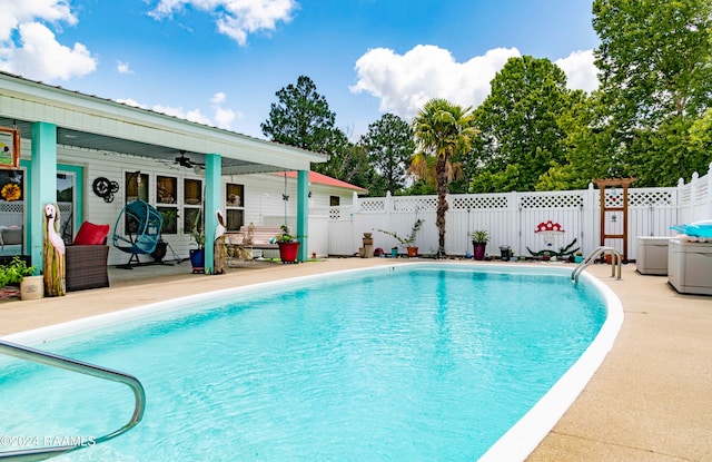 view of pool with ceiling fan and a patio area