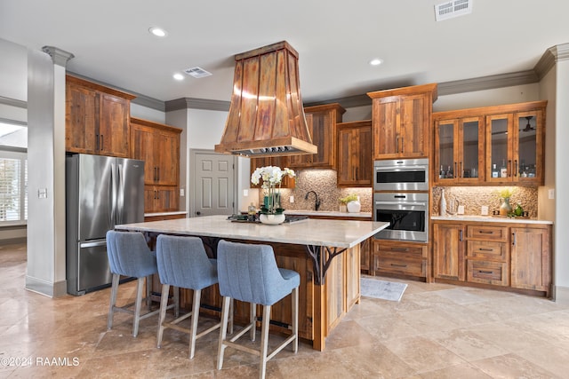 kitchen featuring tasteful backsplash, appliances with stainless steel finishes, crown molding, and a kitchen island