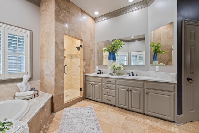 bathroom featuring ornamental molding, shower with separate bathtub, and vanity