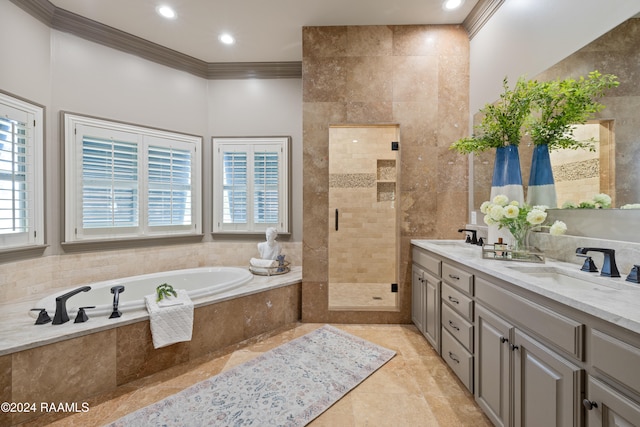 bathroom featuring a healthy amount of sunlight, ornamental molding, shower with separate bathtub, and vanity