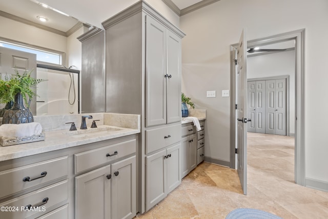 bathroom featuring crown molding, vanity, and a shower