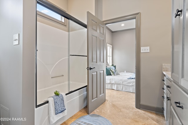 bathroom featuring enclosed tub / shower combo, vanity, and tile patterned flooring