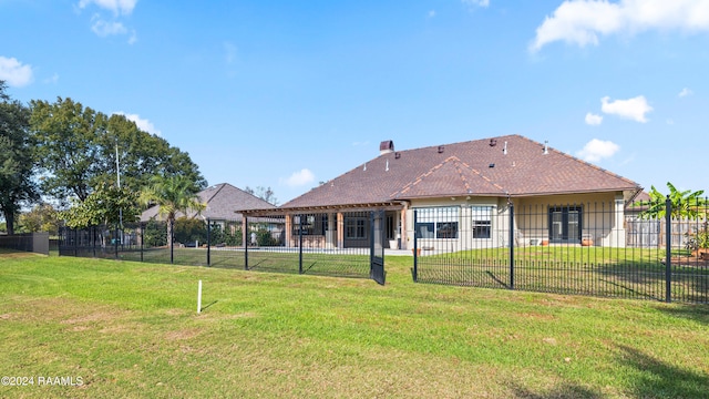 rear view of house with a lawn