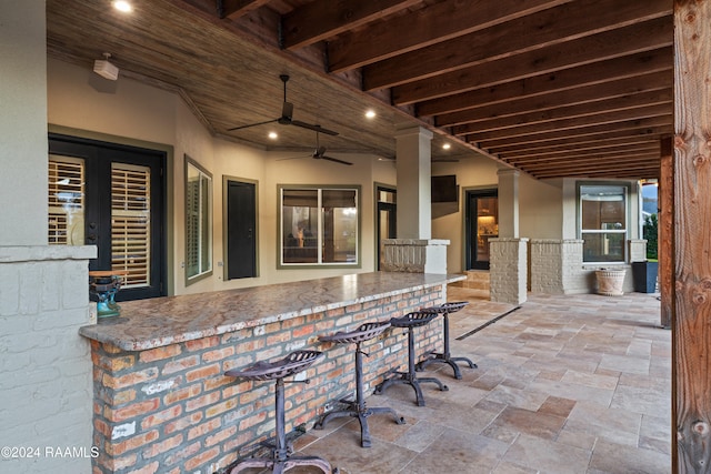 view of patio with an outdoor bar and ceiling fan