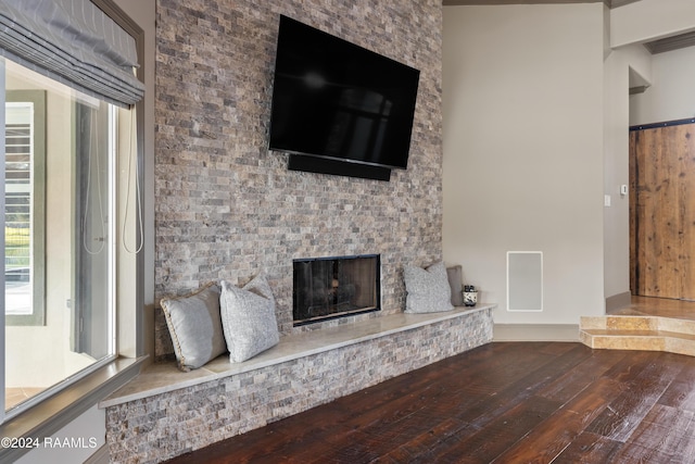 unfurnished living room with hardwood / wood-style flooring and a fireplace