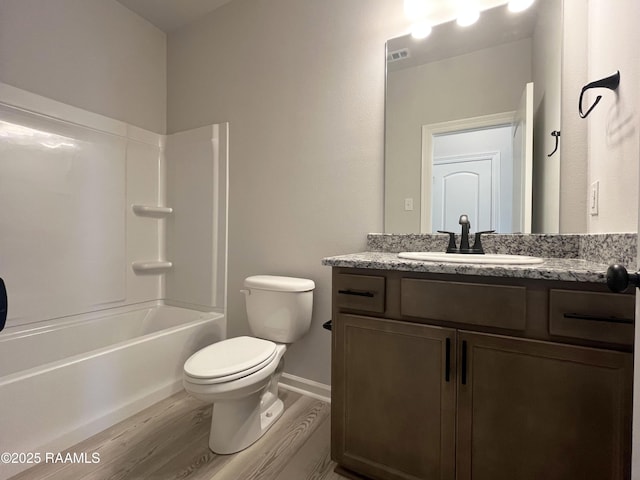 full bathroom with toilet, tub / shower combination, wood-type flooring, and vanity