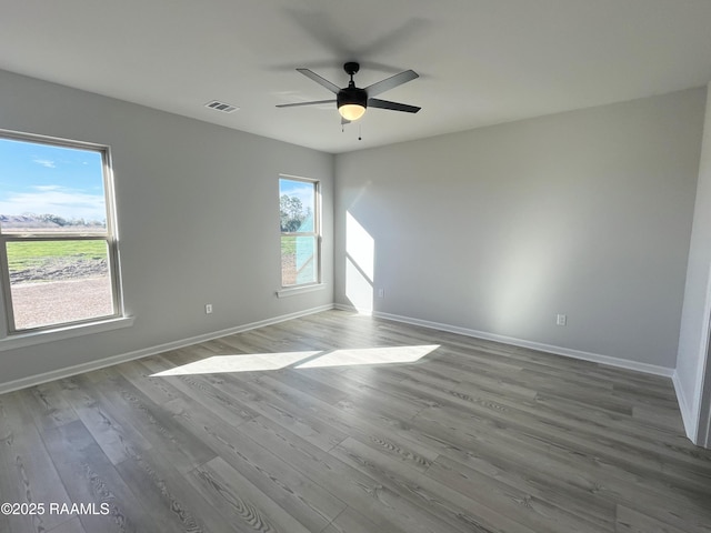 spare room with ceiling fan and hardwood / wood-style flooring