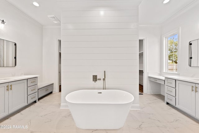 bathroom with a bathtub, vanity, and ornamental molding