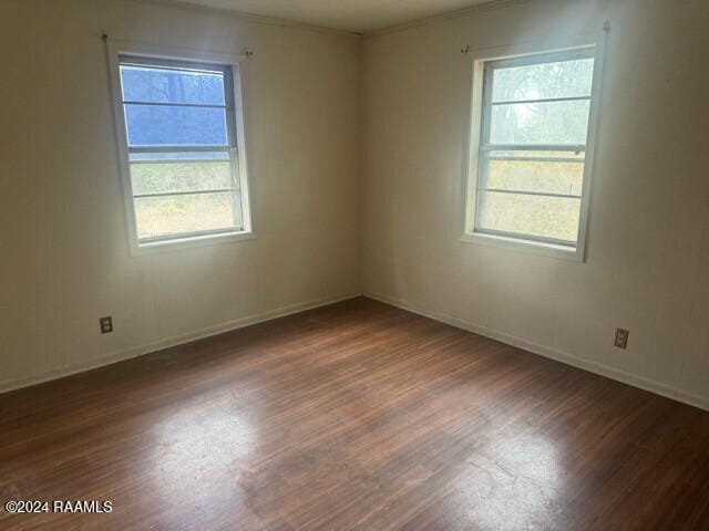 unfurnished room featuring dark hardwood / wood-style flooring