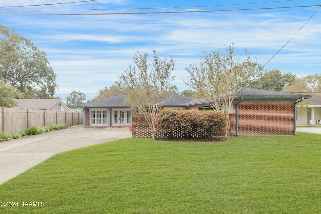 exterior space featuring a front yard and french doors