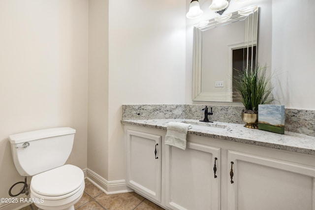 bathroom featuring vanity, tile patterned floors, and toilet