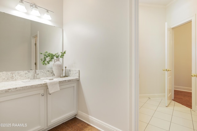 bathroom with ornamental molding, vanity, and tile patterned floors