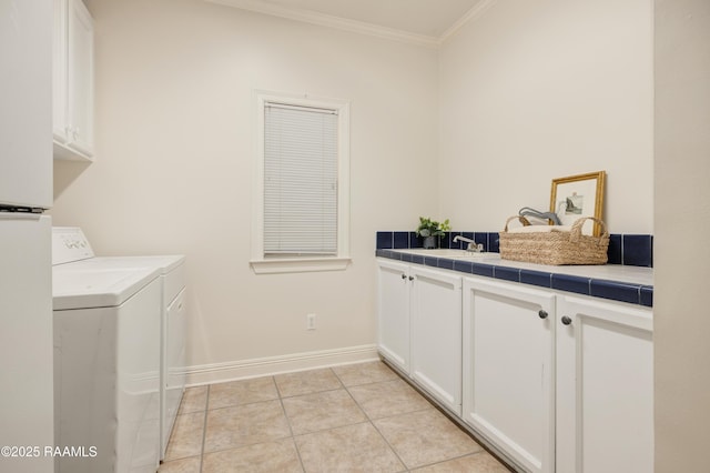 laundry area featuring sink, cabinets, light tile patterned floors, washing machine and clothes dryer, and crown molding