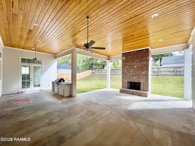 view of patio / terrace with a ceiling fan, french doors, an outdoor brick fireplace, and a fenced backyard