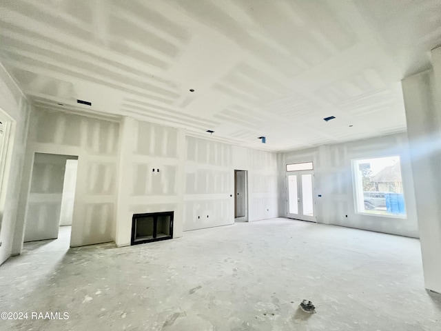unfurnished living room with a fireplace and french doors