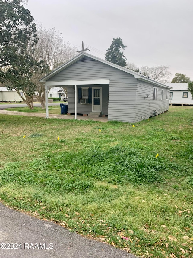 exterior space with cooling unit and a front lawn