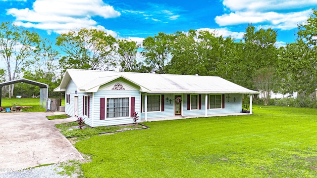 ranch-style home featuring a front lawn, a porch, and a carport