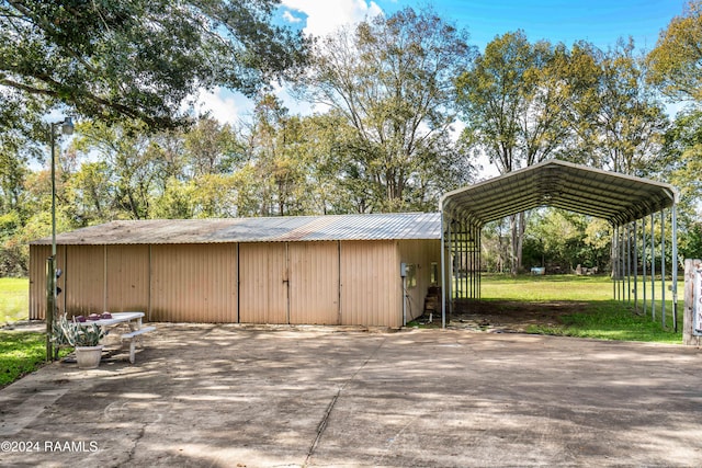 view of outbuilding featuring a lawn and a carport