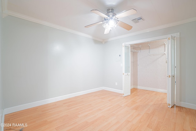 empty room with crown molding, ceiling fan, and light wood-type flooring