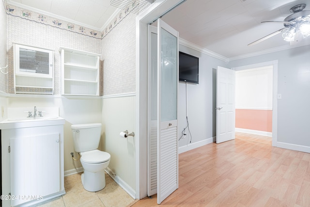 bathroom featuring vanity, ceiling fan, crown molding, wood-type flooring, and toilet