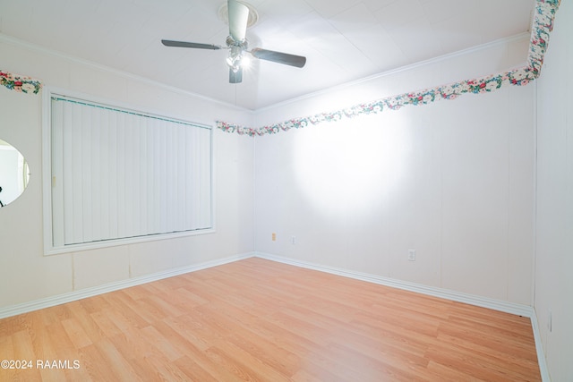 empty room with ceiling fan, hardwood / wood-style floors, and ornamental molding