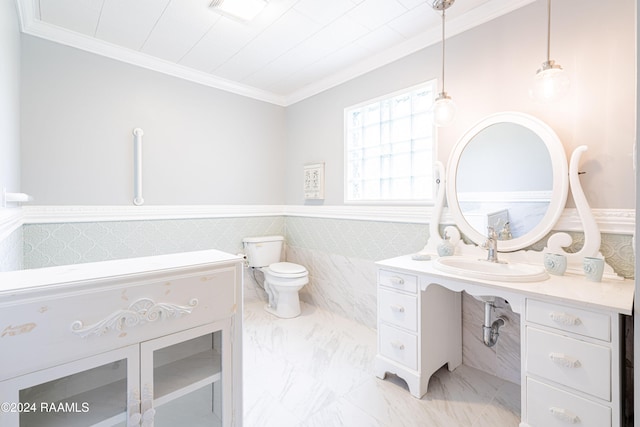 bathroom with crown molding, vanity, tile walls, and toilet