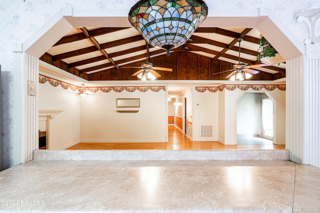 spare room featuring vaulted ceiling with beams and ceiling fan