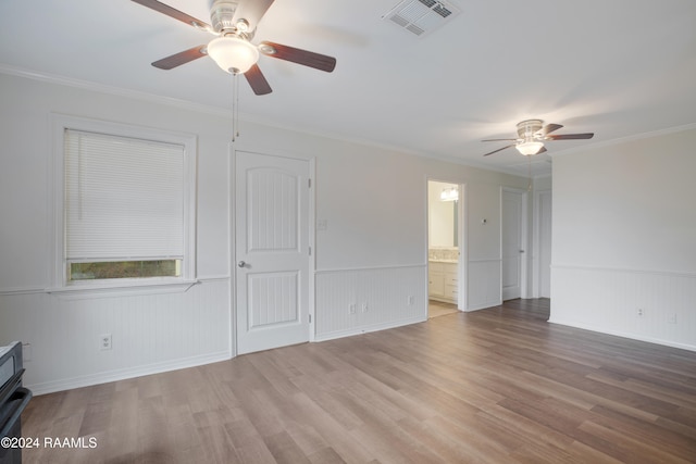 spare room featuring ornamental molding, light hardwood / wood-style floors, and ceiling fan