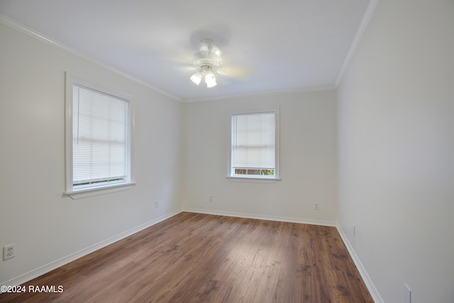 empty room with ornamental molding, dark wood-type flooring, and ceiling fan