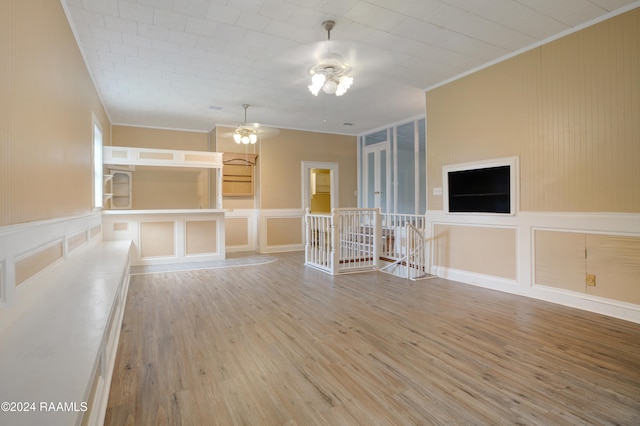 spare room featuring wood-type flooring, ceiling fan, and crown molding