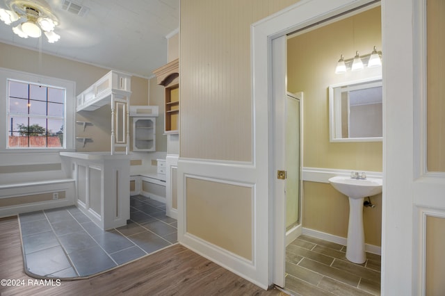 bathroom featuring hardwood / wood-style flooring, ceiling fan, sink, and an enclosed shower