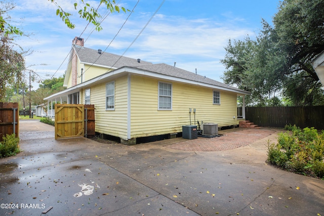 rear view of property with a patio and cooling unit