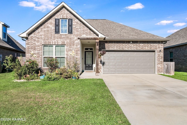 view of property featuring a garage and a front yard