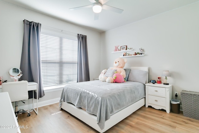 bedroom with ceiling fan and light hardwood / wood-style flooring