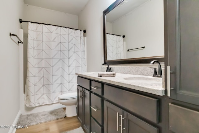 bathroom with hardwood / wood-style floors, vanity, and toilet