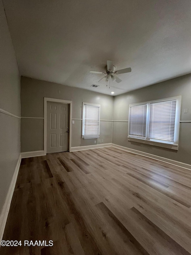 unfurnished room featuring hardwood / wood-style floors and ceiling fan