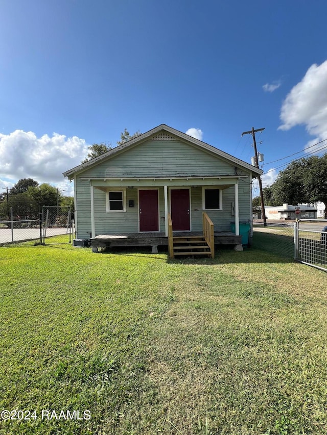 bungalow featuring a front yard and covered porch