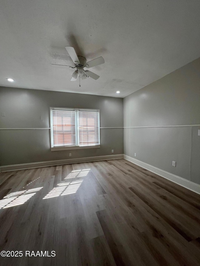 spare room with recessed lighting, a ceiling fan, wood finished floors, and baseboards