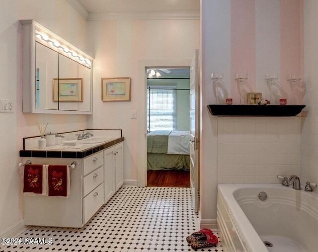 1015 Lee Ave, Lafayette, LA 70501 - bathroom with a bath, baseboards, vanity, connected bathroom, and ornamental molding