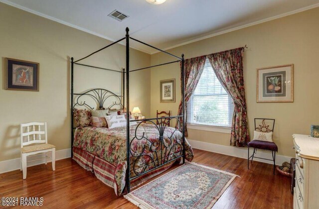 1015 Lee Ave, Lafayette, LA 70501 - bedroom with ornamental molding, wood finished floors, and baseboards