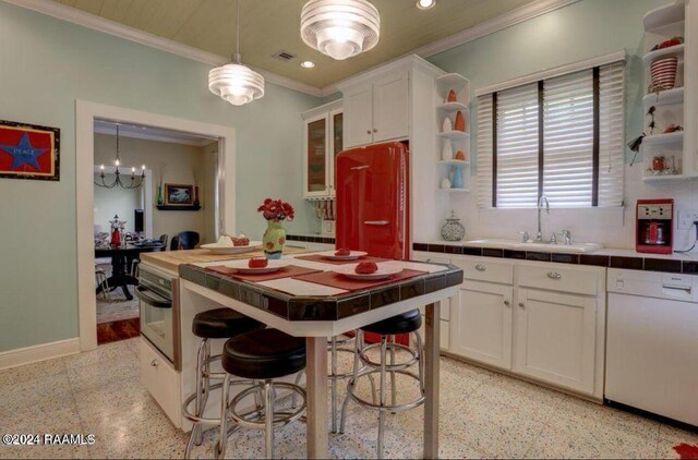 1015 Lee Ave, Lafayette, LA 70501 - kitchen featuring dishwasher, dark speckled floor, tile counters, refrigerator, and crown molding