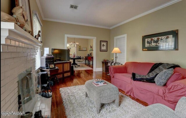 1015 Lee Ave, Lafayette, LA 70501 - living room featuring a chandelier, wood finished floors, ornamental molding, a fireplace, and healthy amount of natural light